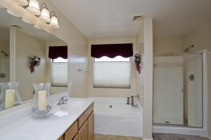 3815 East Chickadee Road Gilbert, AZ 85297 - Photo 5 of 9 a bathroom with a sink a mirror and a shower