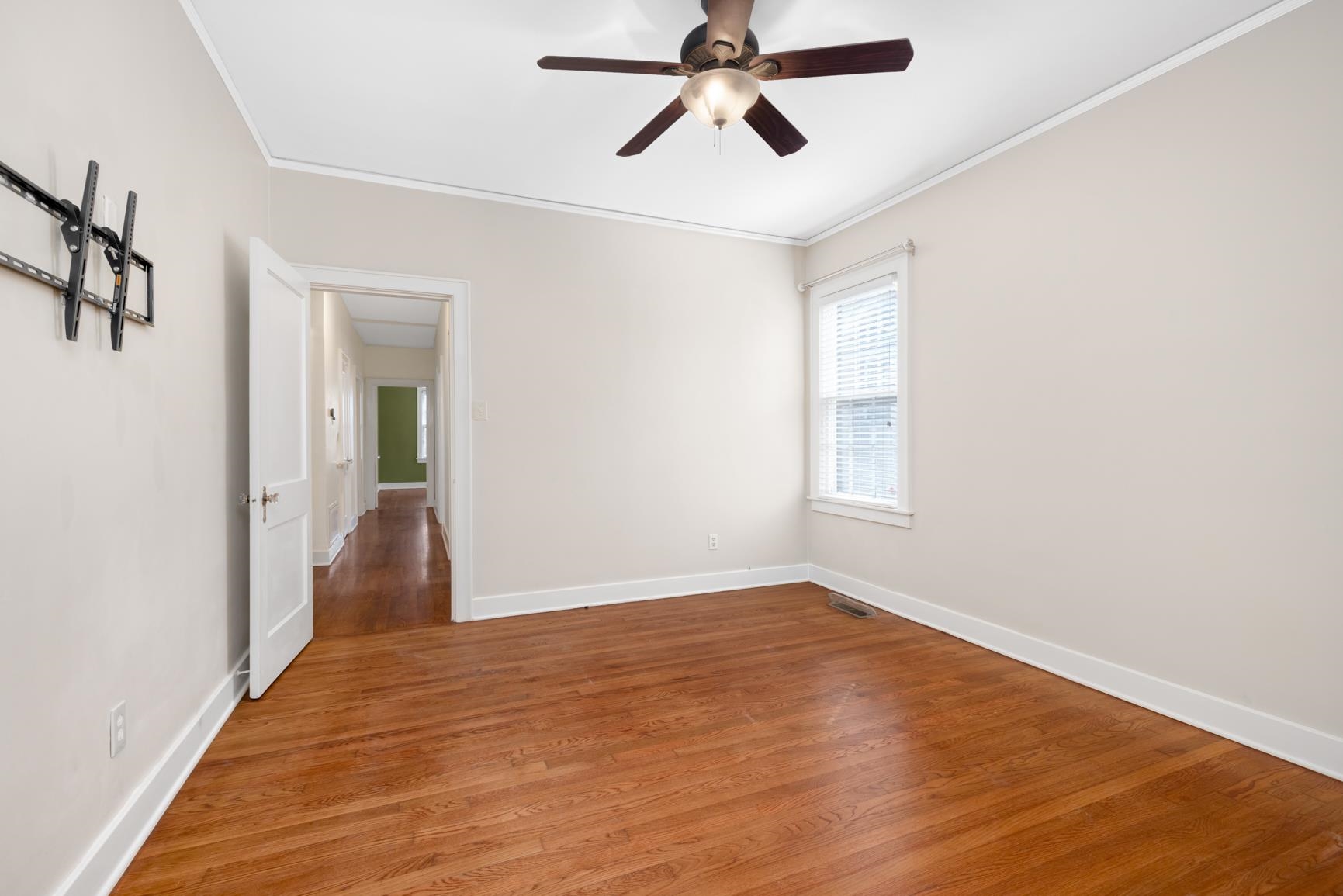 331 Alexander Street Memphis, TN 38111 - Photo 19 of 25 Empty room with wood finished floors, crown molding, and ceiling fan