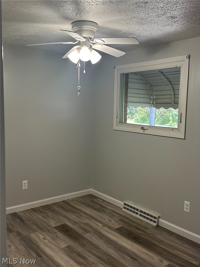 1001 Keefer Road Girard, OH 44420 - Photo 18 of 42 Bedroom featuring a textured ceiling, hardwood / wood-style flooring, and ceiling fan