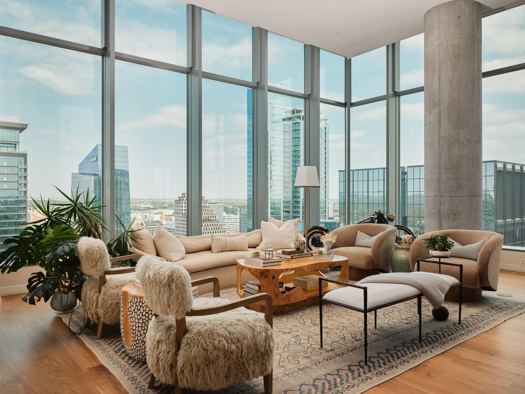 Living room featuring light wood-style floors, a city view, healthy amount of natural light, and a wall of windows