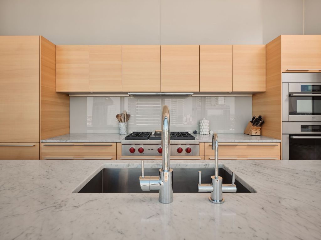 210 Lavaca Street, Unit 3504 Austin, TX 78701 - Photo 16 of 40 a kitchen with kitchen island granite countertop a stove and a cabinets