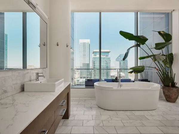 a bathroom with a tub shower and sink