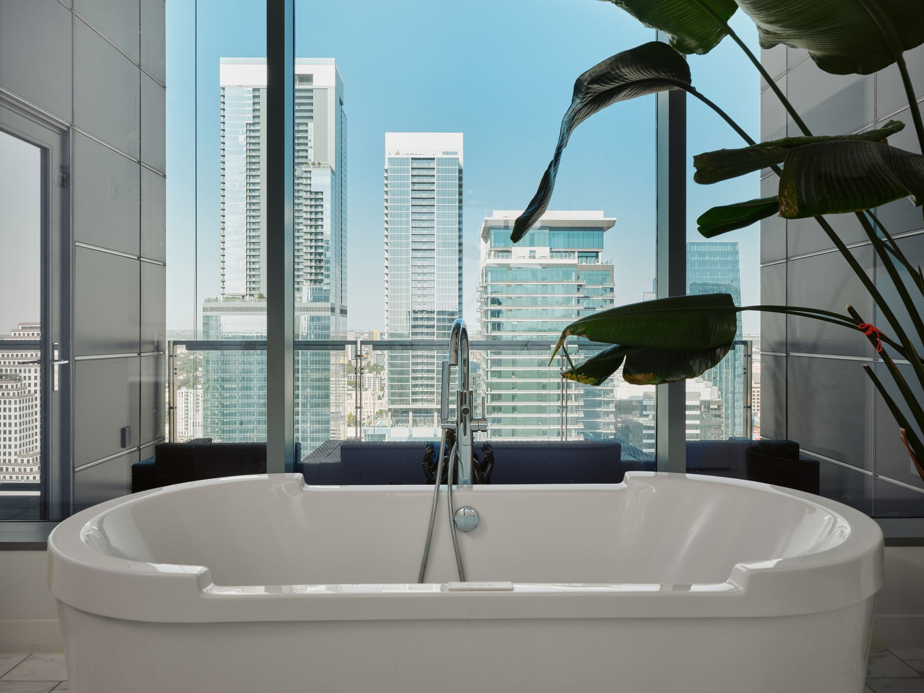 210 Lavaca Street, Unit 3504 Austin, TX 78701 - Photo 28 of 40 Full bathroom featuring a city view and a freestanding bath