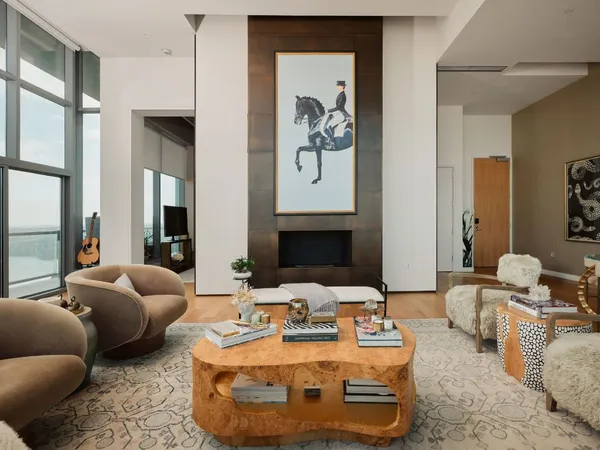 a living room with furniture and a floor to ceiling window