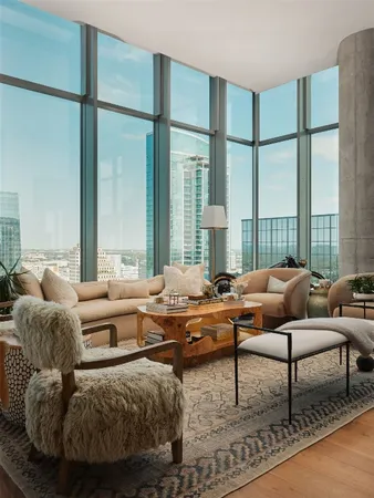 a view of living room with a floor to ceiling window and wooden floor