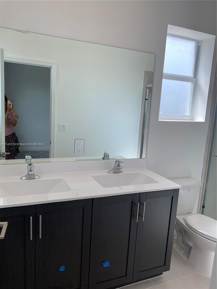 Homestead Homestead, FL 33035 - Photo 4 of 11 a bathroom with a sink a toilet and mirror