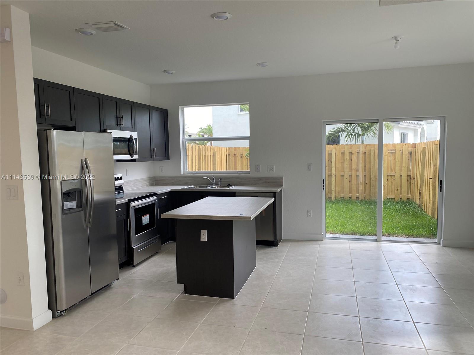 Homestead Homestead, FL 33035 - Photo 6 of 11 a kitchen with kitchen island a stove a refrigerator and a sink