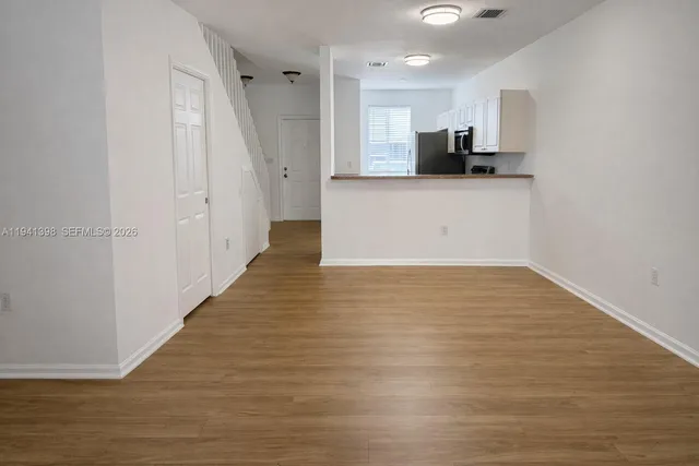 a view of a kitchen with a sink and cabinets