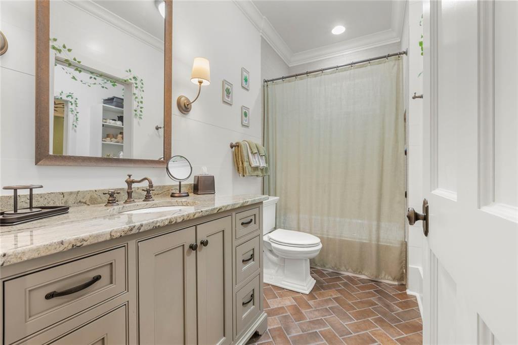 1982 West Rugby Avenue Atlanta, GA 30337 - Photo 37 of 42 a bathroom with a granite countertop sink toilet and shower