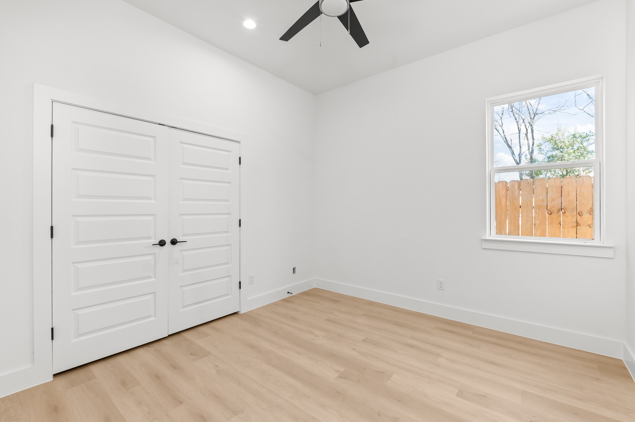 5903 Doolittle Boulevard Houston, TX 77033 - Photo 14 of 30 wooden floor in an empty room with a window