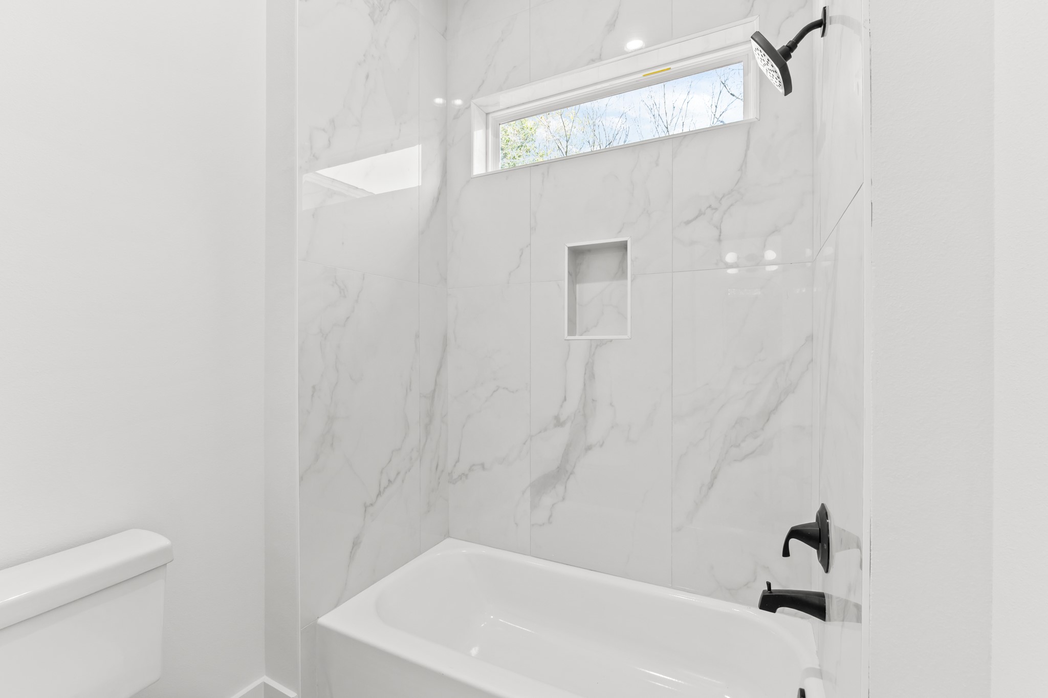 5903 Doolittle Boulevard Houston, TX 77033 - Photo 16 of 30 a bathroom with a white bath tub and a shower curtain