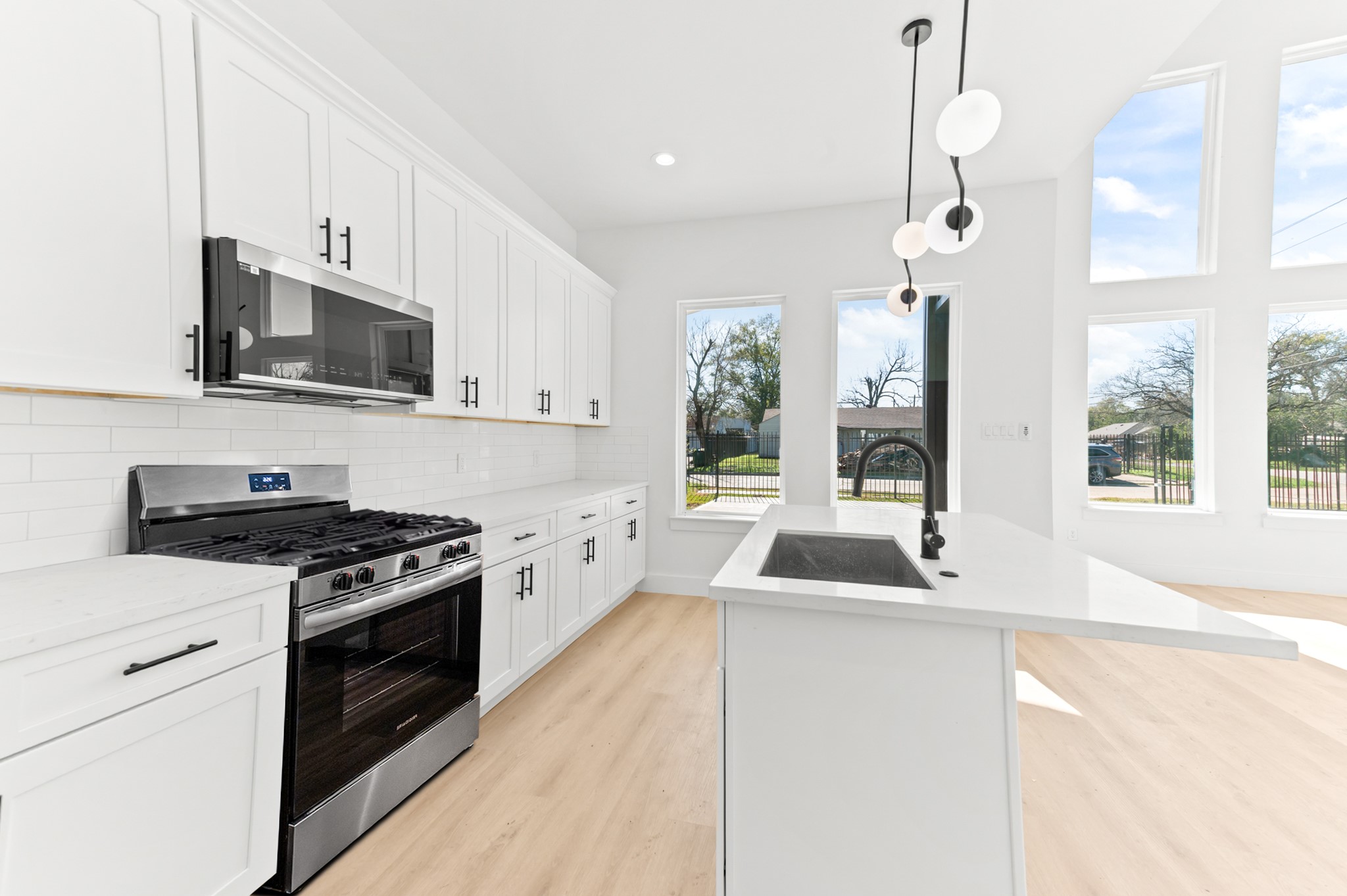 5903 Doolittle Boulevard Houston, TX 77033 - Photo 2 of 30 a kitchen with granite countertop a sink and a stove top oven