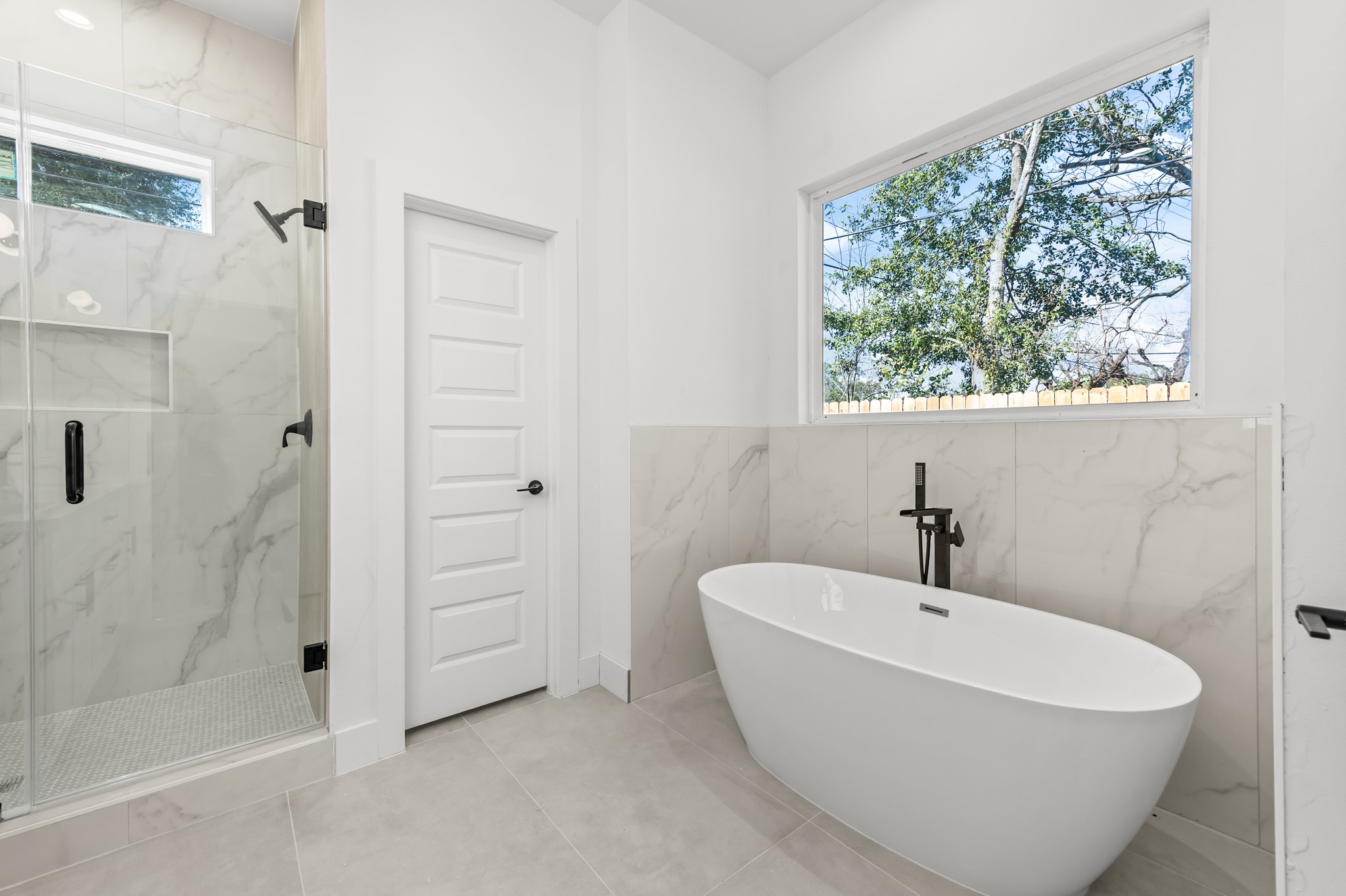 5903 Doolittle Boulevard Houston, TX 77033 - Photo 25 of 30 a white bath tub sitting next to a shower