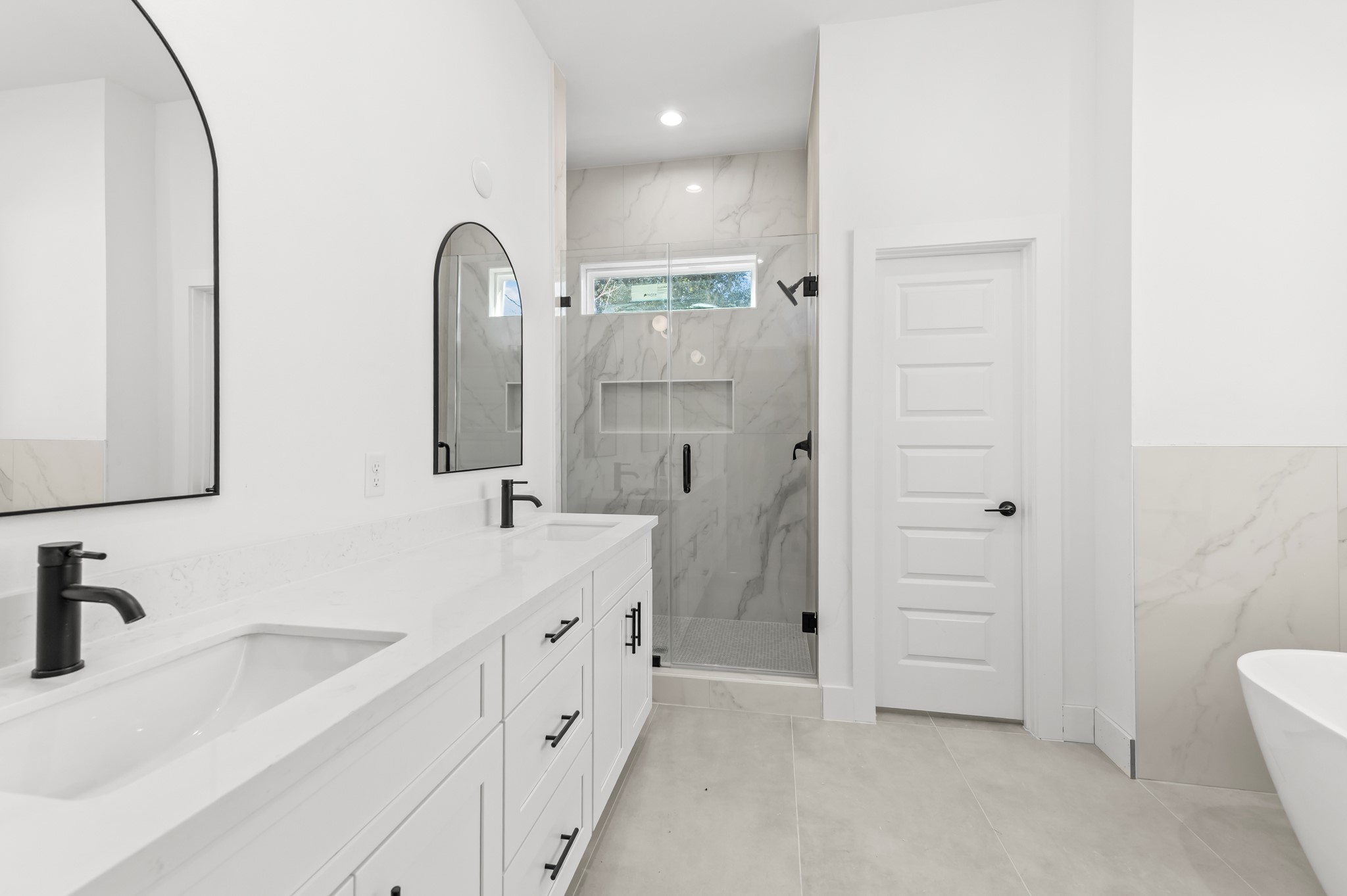 5903 Doolittle Boulevard Houston, TX 77033 - Photo 26 of 30 a en suite bathroom with a double vanity sink a mirror and a shower