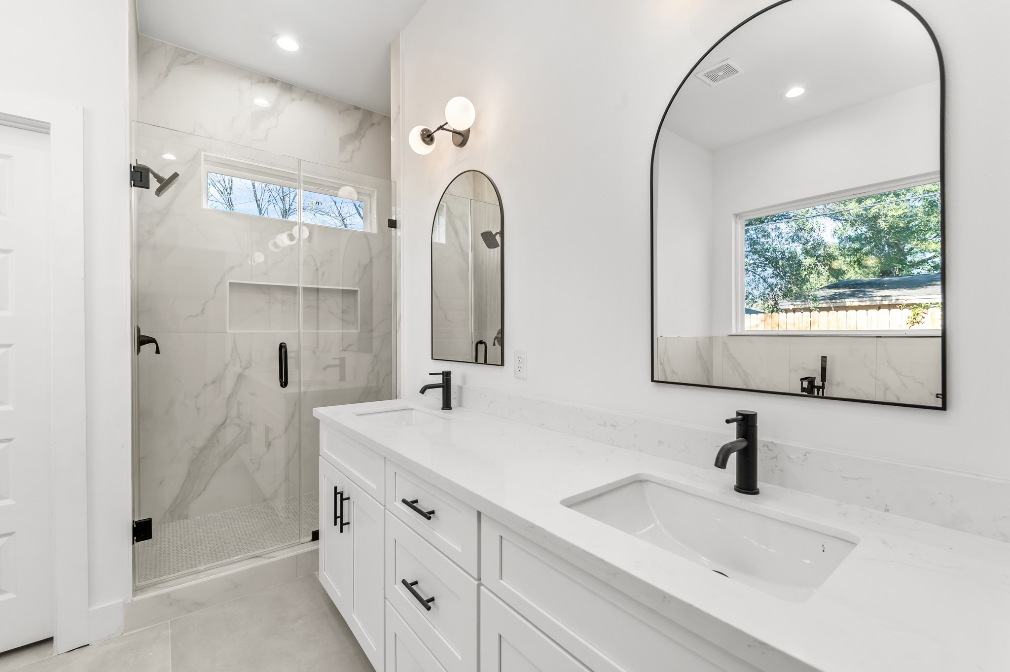 5903 Doolittle Boulevard Houston, TX 77033 - Photo 30 of 30 a bathroom with a double vanity sink mirror and shower