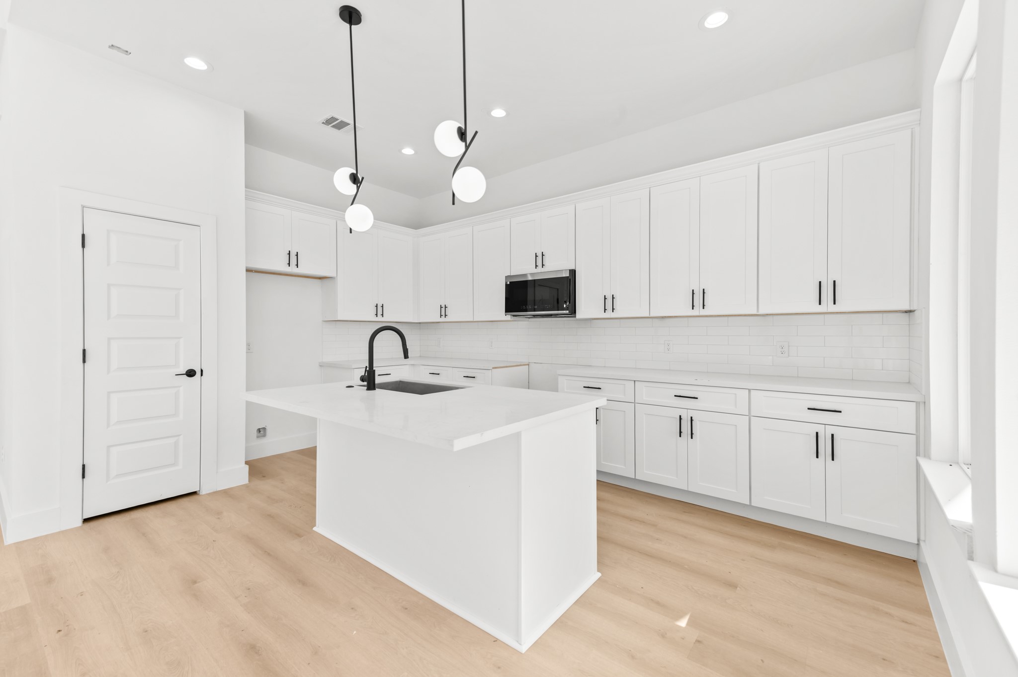 5903 Doolittle Boulevard Houston, TX 77033 - Photo 8 of 30 a kitchen with white cabinets and sink