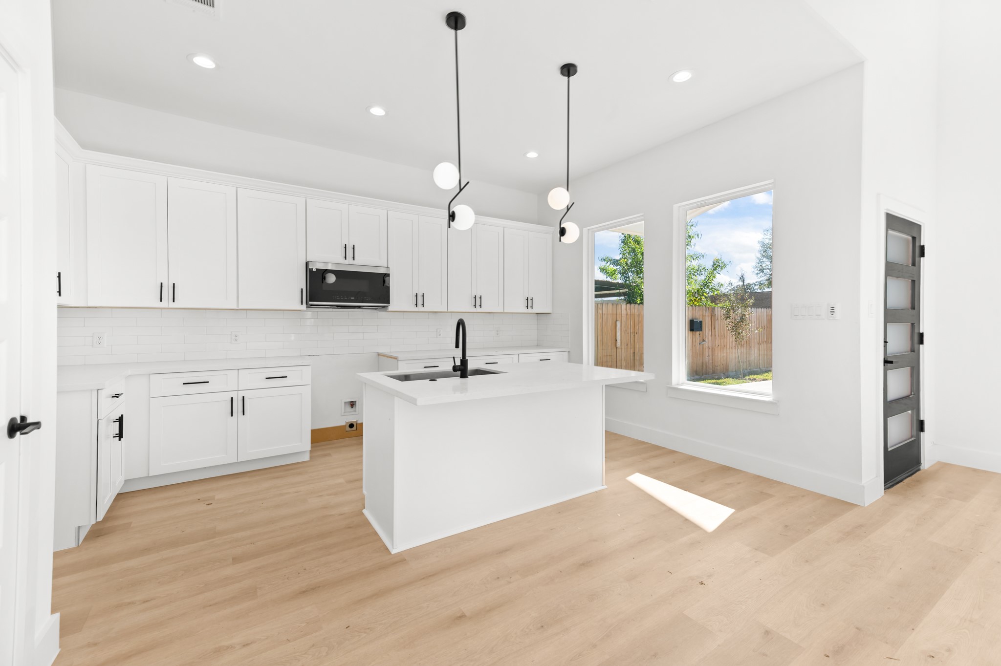 5903 Doolittle Boulevard Houston, TX 77033 - Photo 9 of 30 a view of a kitchen with kitchen island a sink stainless steel appliances and cabinets