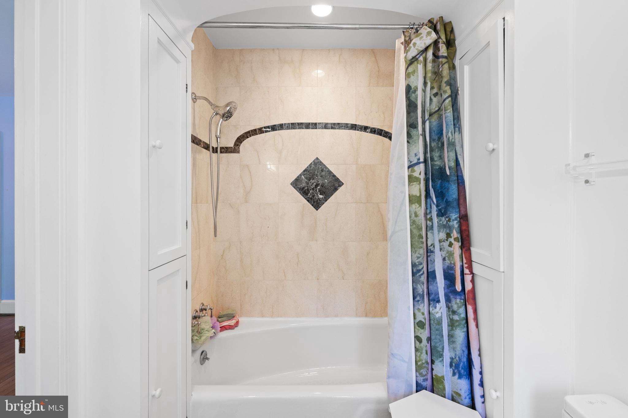 1702 Kalmia Road Northwest Washington, DC 20012 - Photo 25 of 55 a bathroom with a shower and a tub
