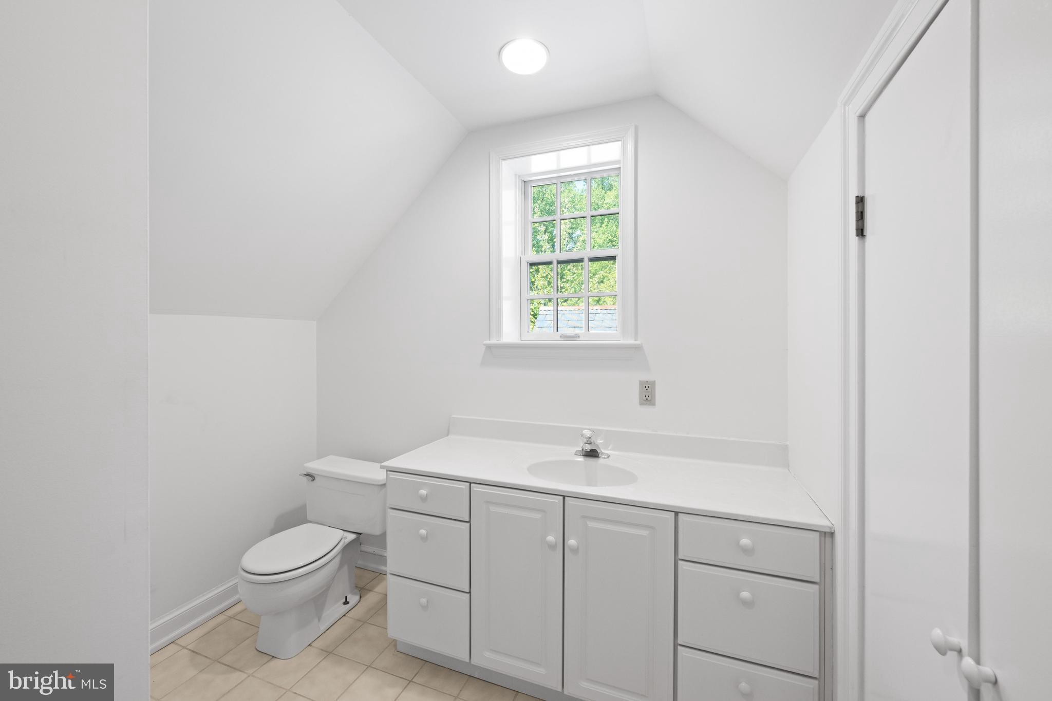 1702 Kalmia Road Northwest Washington, DC 20012 - Photo 32 of 55 a bathroom with a toilet a sink a window and mirror