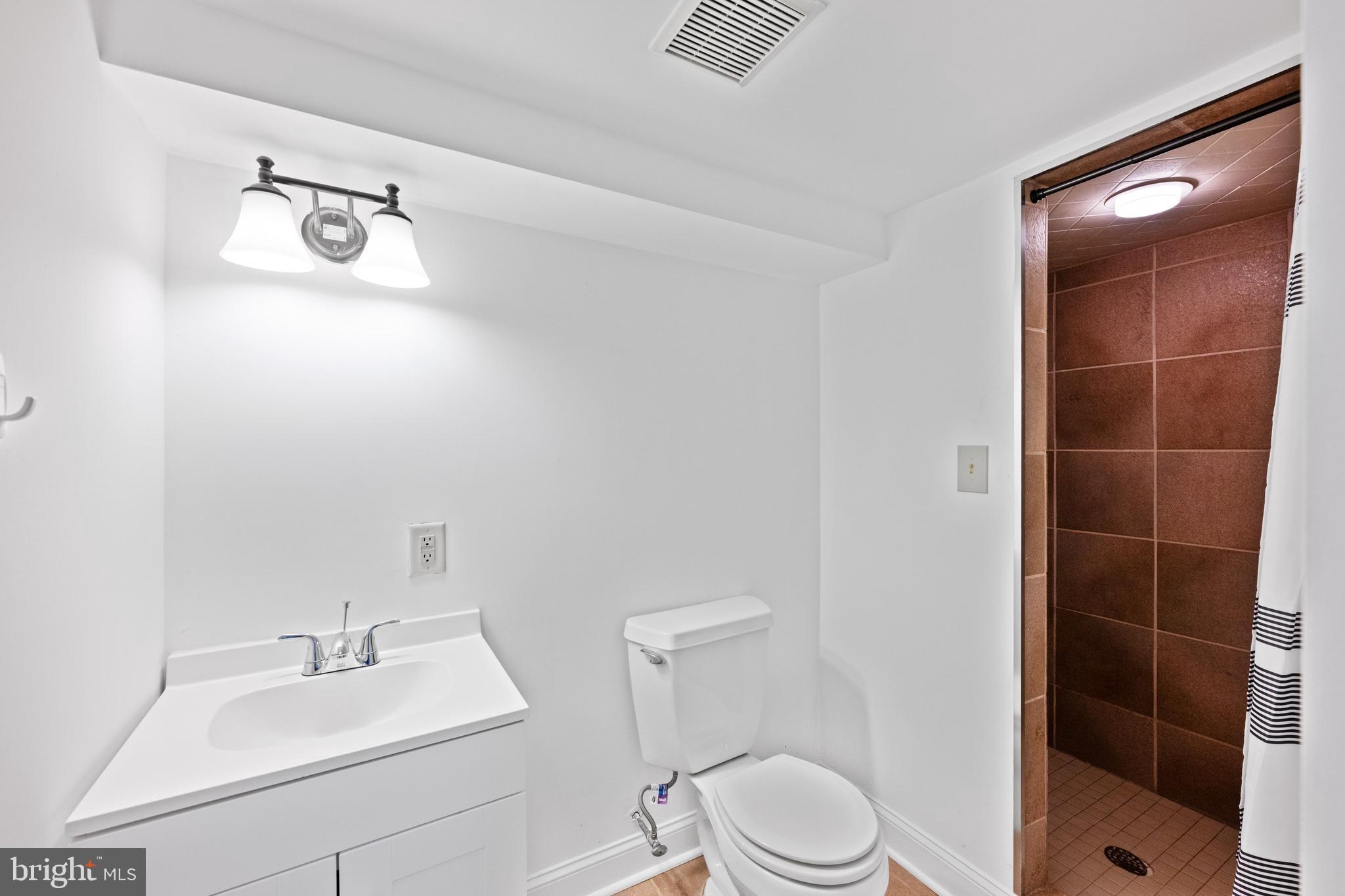 1702 Kalmia Road Northwest Washington, DC 20012 - Photo 38 of 55 a bathroom with a sink a toilet and shower