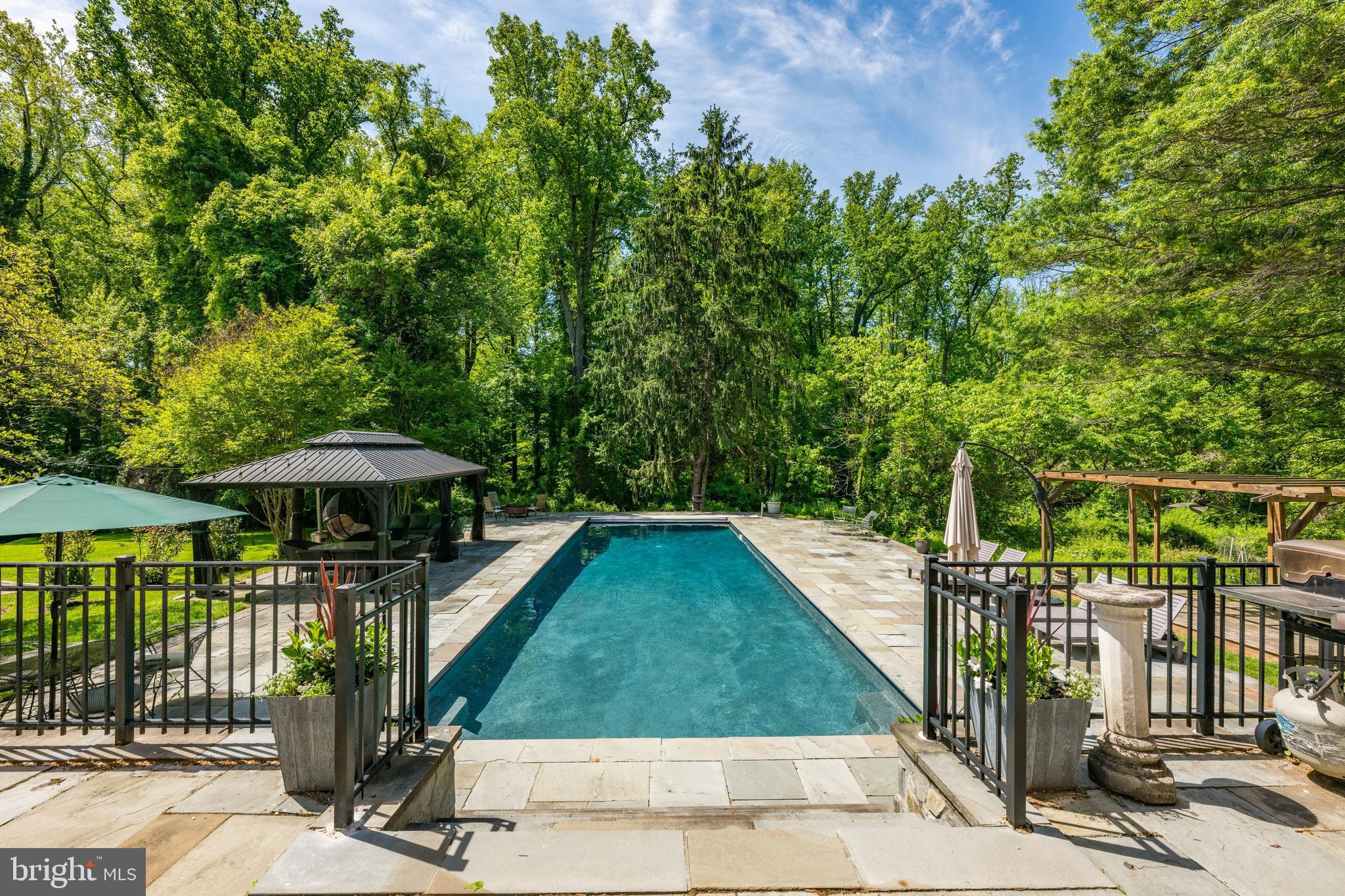 1702 Kalmia Road Northwest Washington, DC 20012 - Photo 42 of 55 a view of a patio with chairs under an umbrella