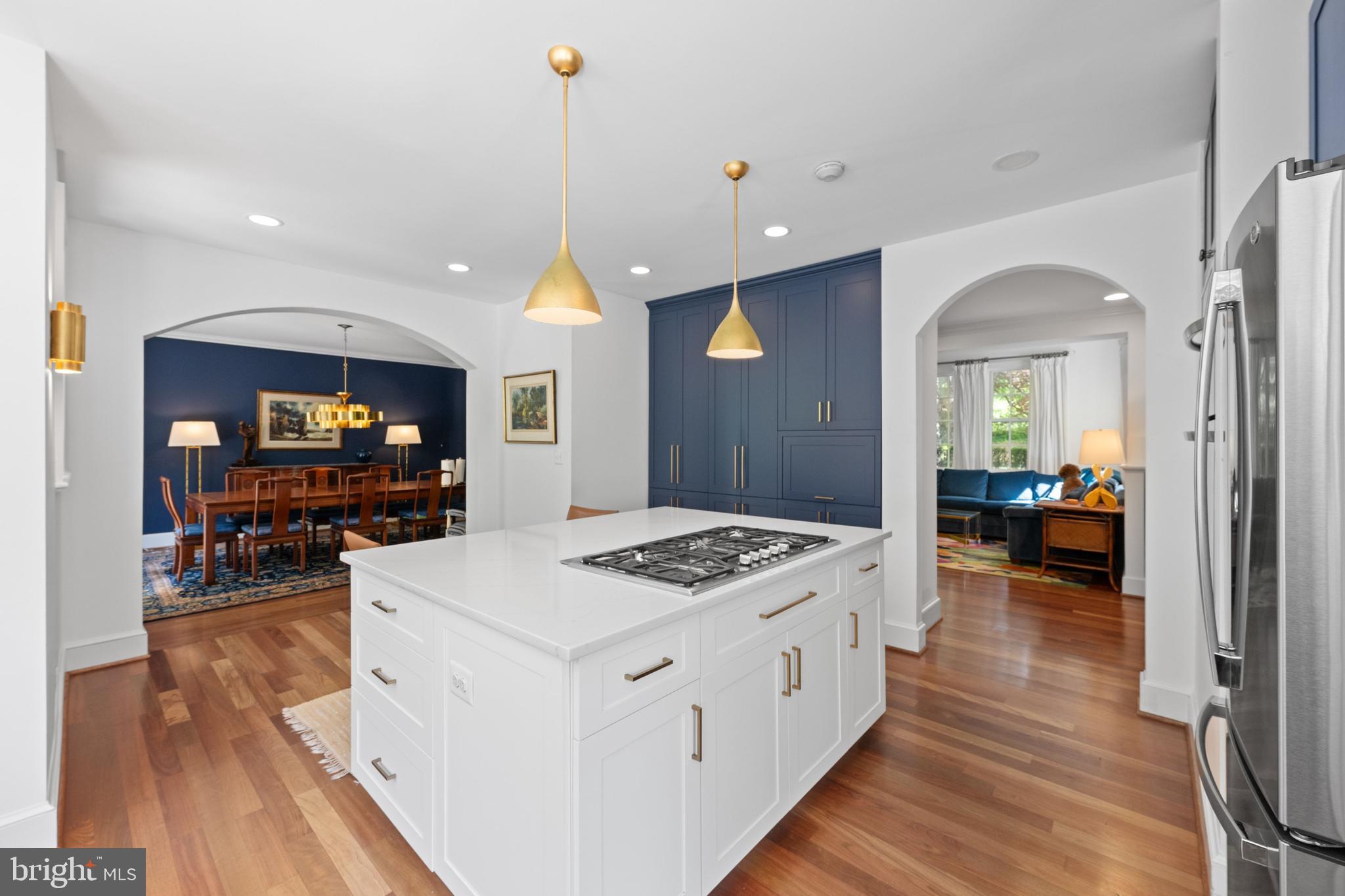 1702 Kalmia Road Northwest Washington, DC 20012 - Photo 8 of 55 a open kitchen with stainless steel appliances kitchen island a stove and a wooden floors