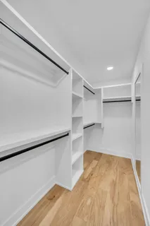 a view of walk in closet with empty racks