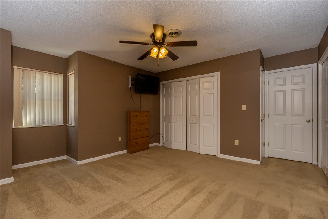 1302 Leeward Road Anderson, SC 29625 - Photo 26 of 50 A well-lit bedroom features plush carpeting and convenient closet space.