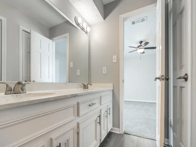 a bathroom with a double vanity sink and mirror