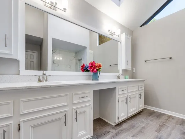 a bathroom with a sink vanity and mirror