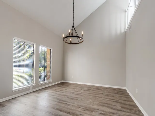 a view of a room with wooden floor and fan