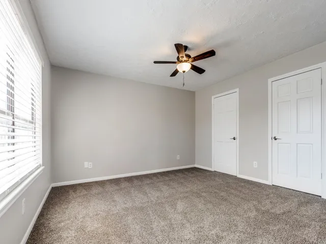 a view of room with a ceiling fan and window