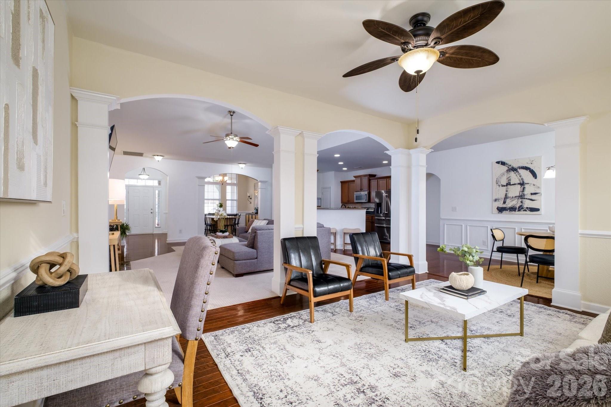 a living room with furniture and kitchen view