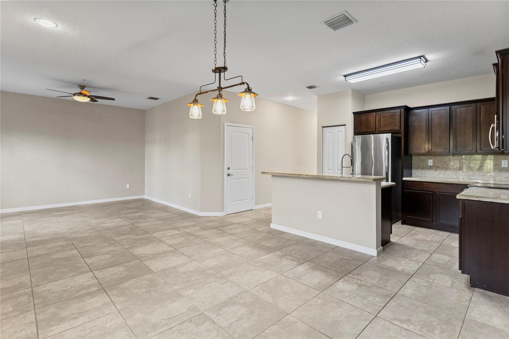 259 Southwest 7th Street, Unit 259 Pompano Beach, FL 33060 - Photo 16 of 87 a view of a kitchen with a sink and chandelier