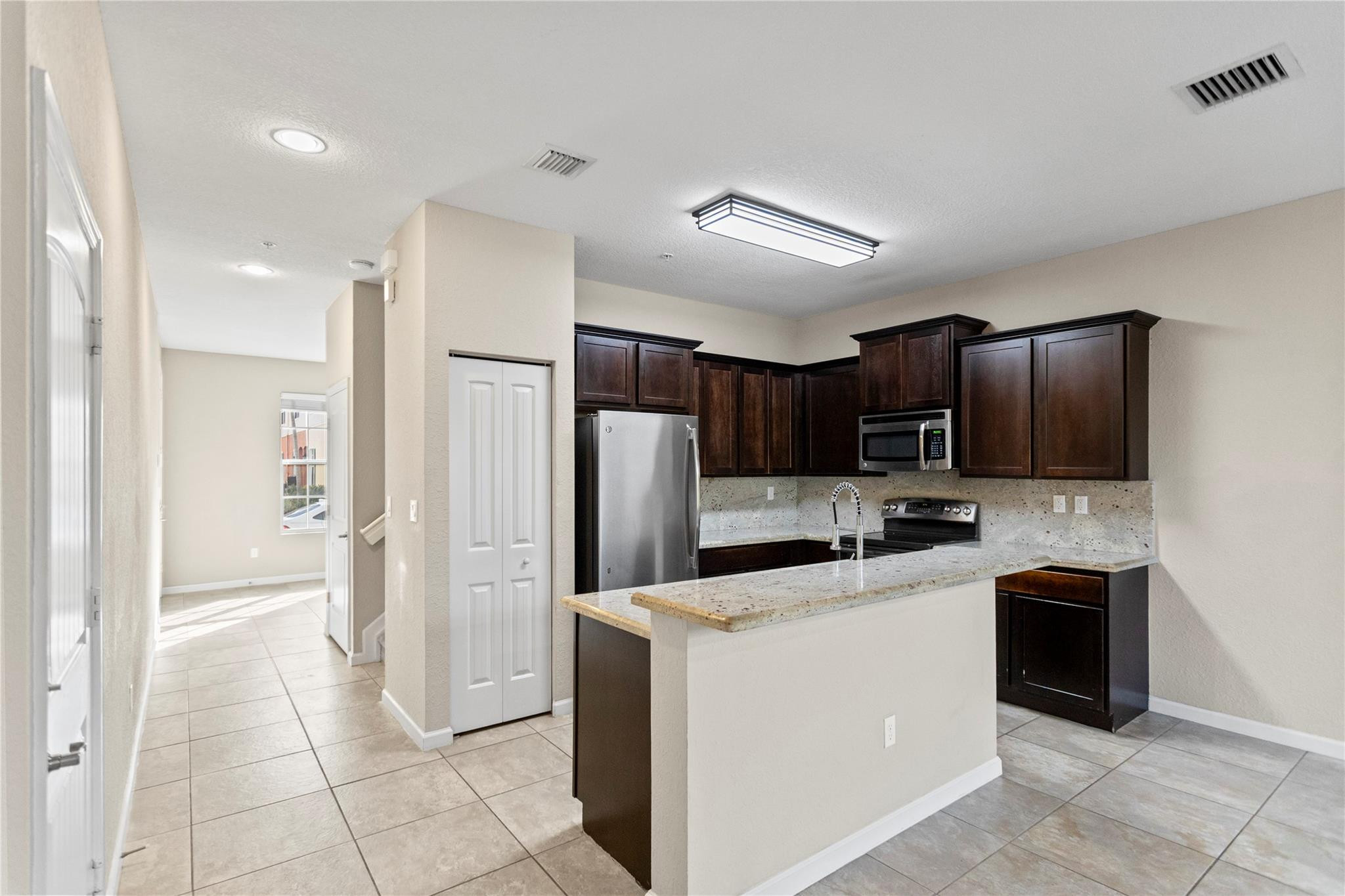 259 Southwest 7th Street, Unit 259 Pompano Beach, FL 33060 - Photo 28 of 87 a kitchen with stainless steel appliances a refrigerator sink and microwave