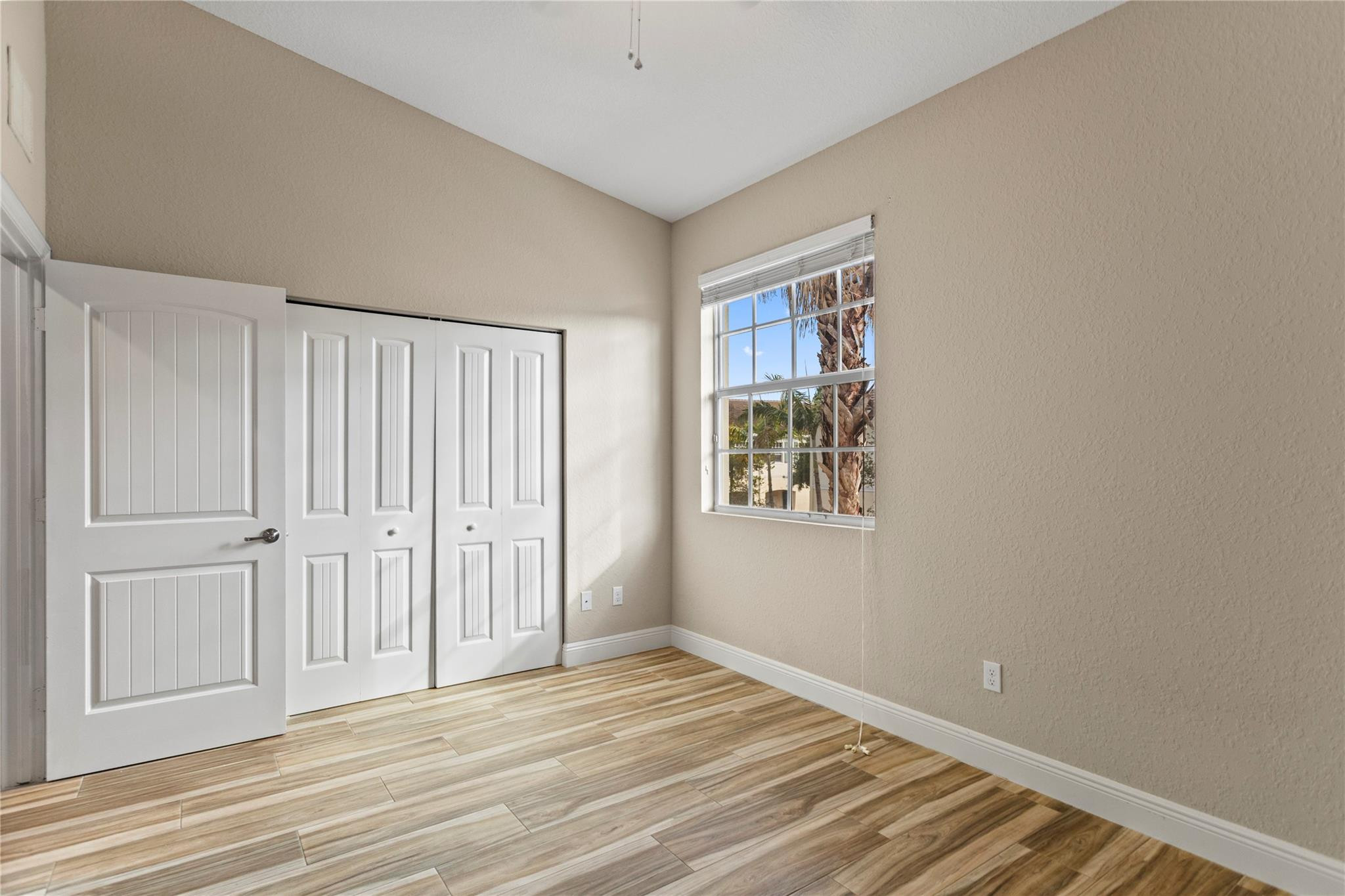 259 Southwest 7th Street, Unit 259 Pompano Beach, FL 33060 - Photo 32 of 87 a view of a room with wooden floor and window