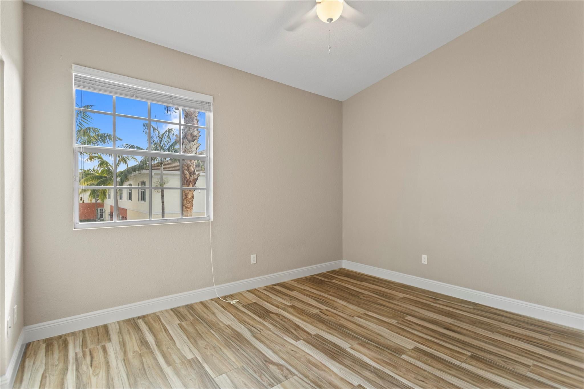 259 Southwest 7th Street, Unit 259 Pompano Beach, FL 33060 - Photo 35 of 87 a view of empty room with wooden floor and fan