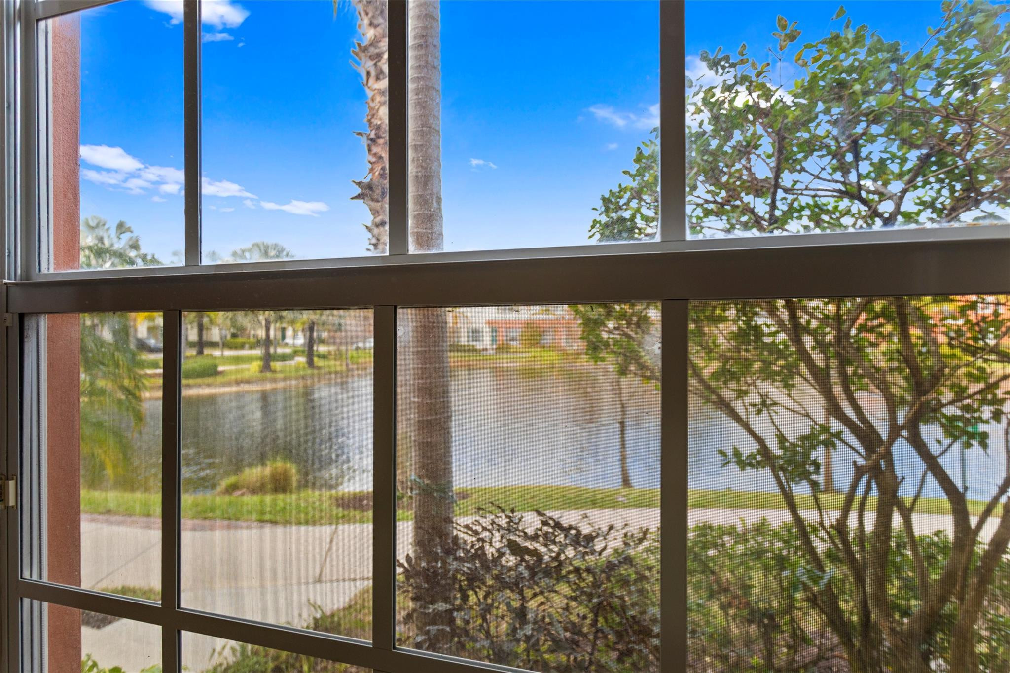 259 Southwest 7th Street, Unit 259 Pompano Beach, FL 33060 - Photo 36 of 87 a view of a glass door with a tree