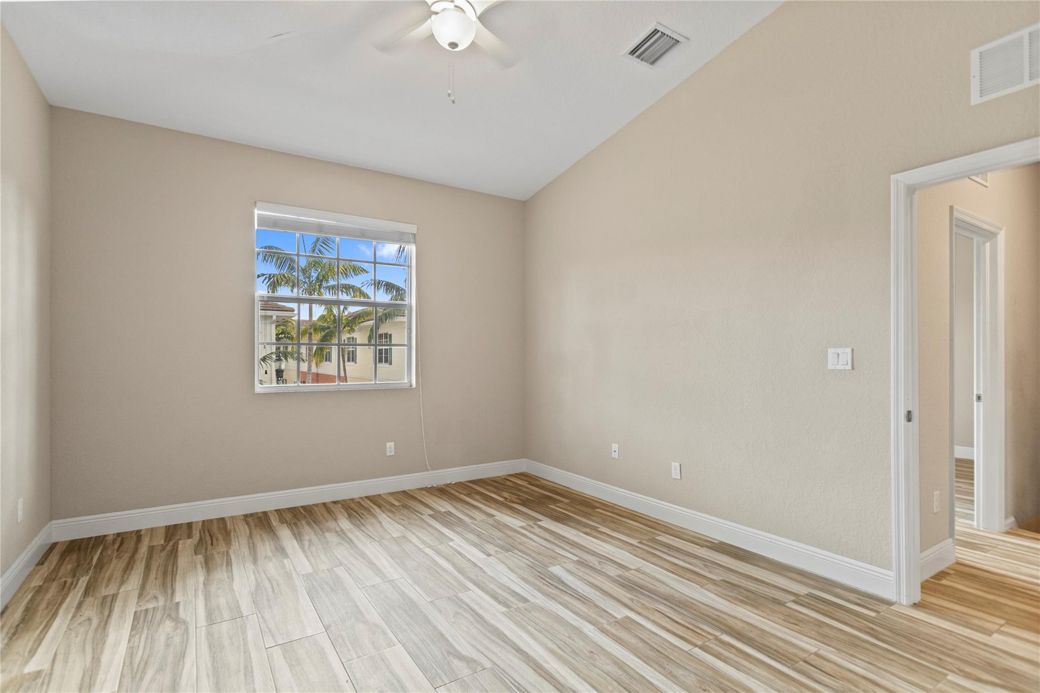 259 Southwest 7th Street, Unit 259 Pompano Beach, FL 33060 - Photo 44 of 87 wooden floor in an empty room with a window