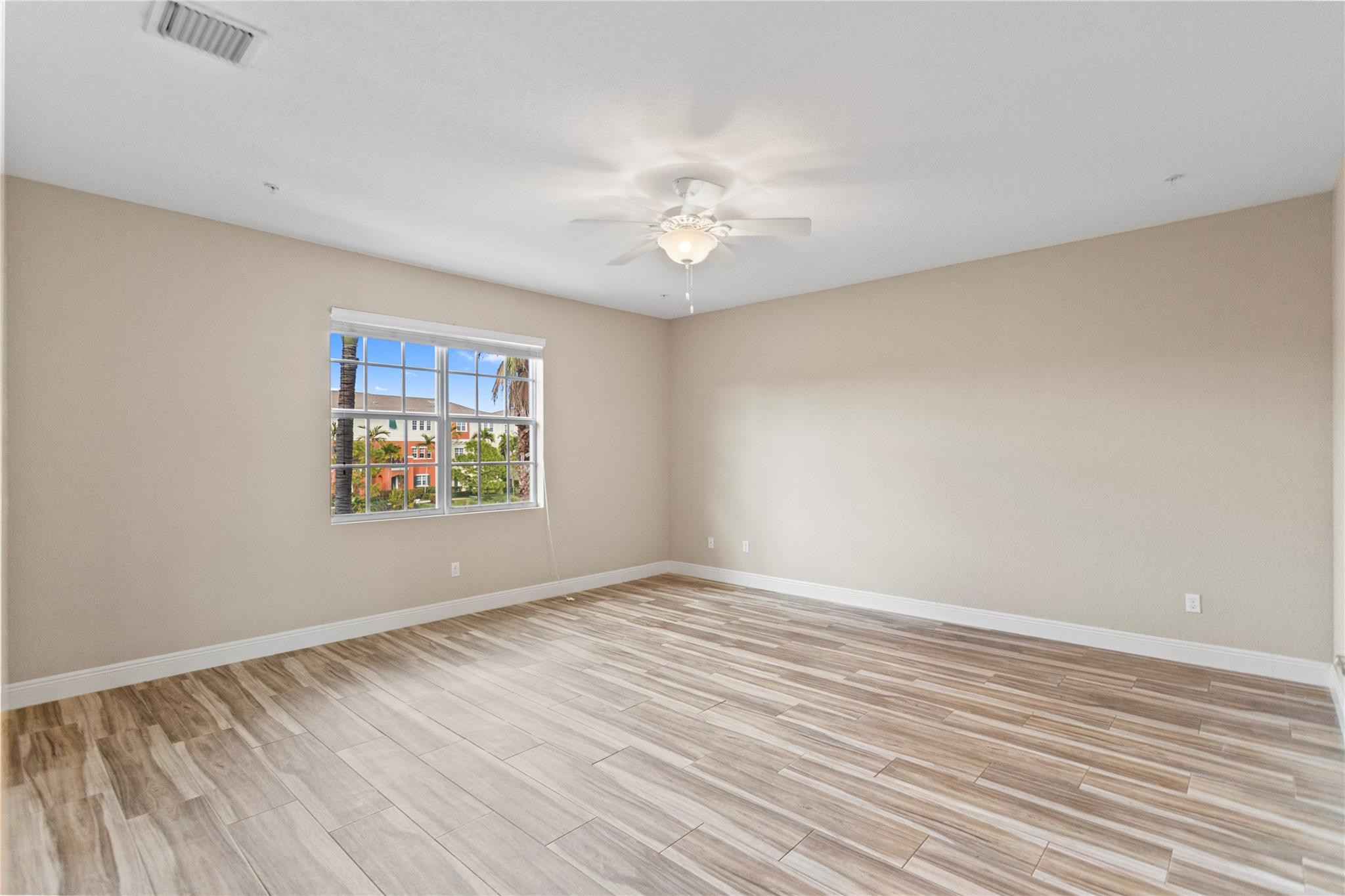 259 Southwest 7th Street, Unit 259 Pompano Beach, FL 33060 - Photo 45 of 87 wooden floor in an empty room with a window