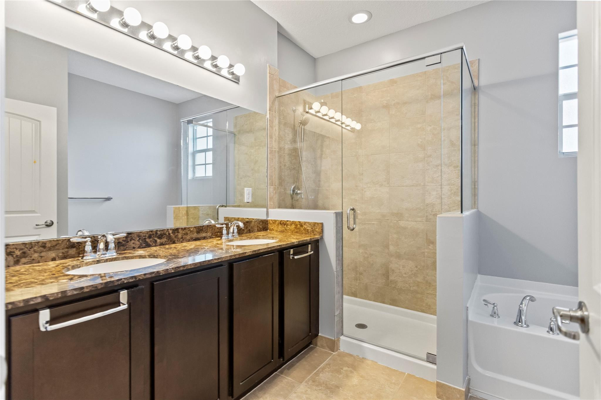 259 Southwest 7th Street, Unit 259 Pompano Beach, FL 33060 - Photo 54 of 87 a bathroom with a granite countertop sink and a mirror