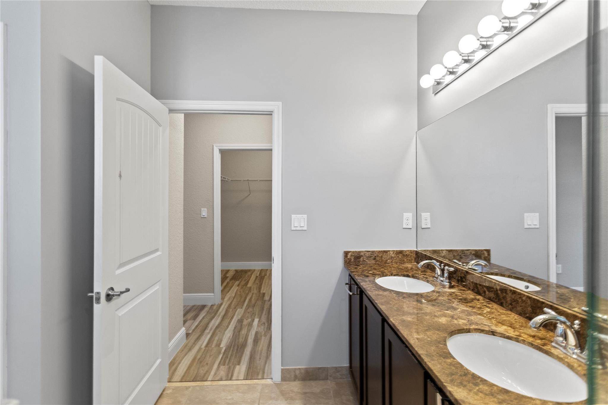 259 Southwest 7th Street, Unit 259 Pompano Beach, FL 33060 - Photo 59 of 87 a bathroom with a granite countertop sink and a mirror
