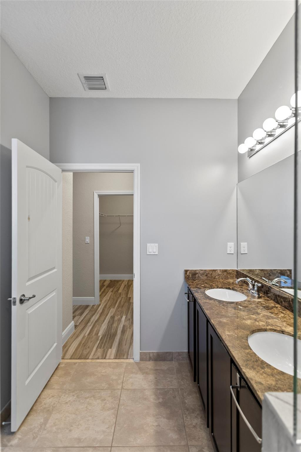259 Southwest 7th Street, Unit 259 Pompano Beach, FL 33060 - Photo 60 of 87 a bathroom with a granite countertop sink and a mirror