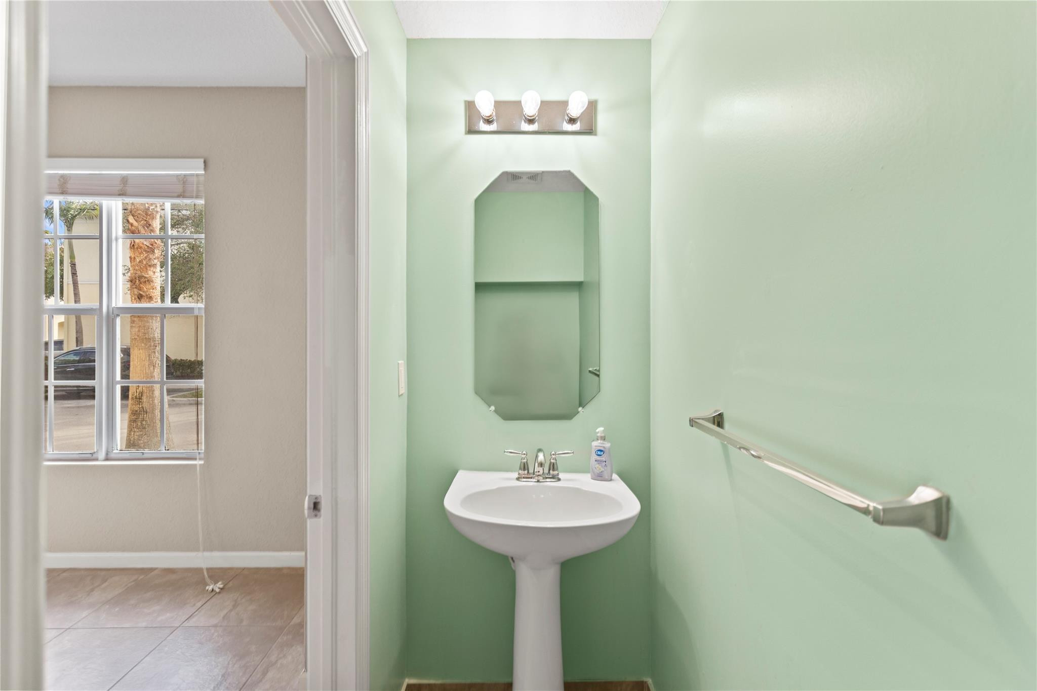 259 Southwest 7th Street, Unit 259 Pompano Beach, FL 33060 - Photo 7 of 87 a bathroom with a sink and mirror