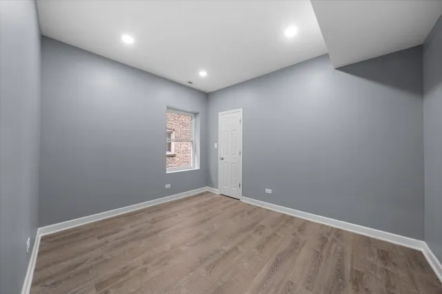 an empty room with windows and closet