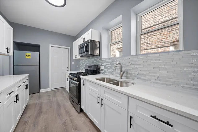 a kitchen with a sink stove and cabinets