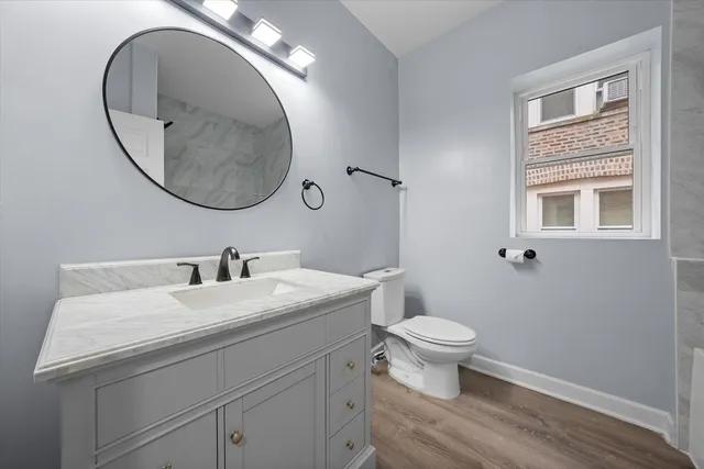 a bathroom with a sink a toilet and a mirror