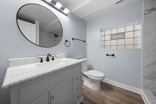 a bathroom with a sink a toilet and a mirror