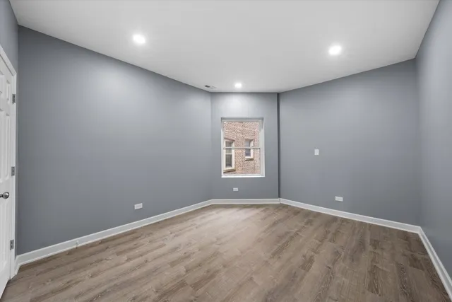an empty room with windows and closet