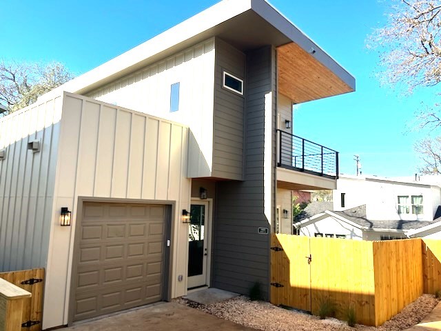 View of the front of this custom-built modern home and spacious fenced yard